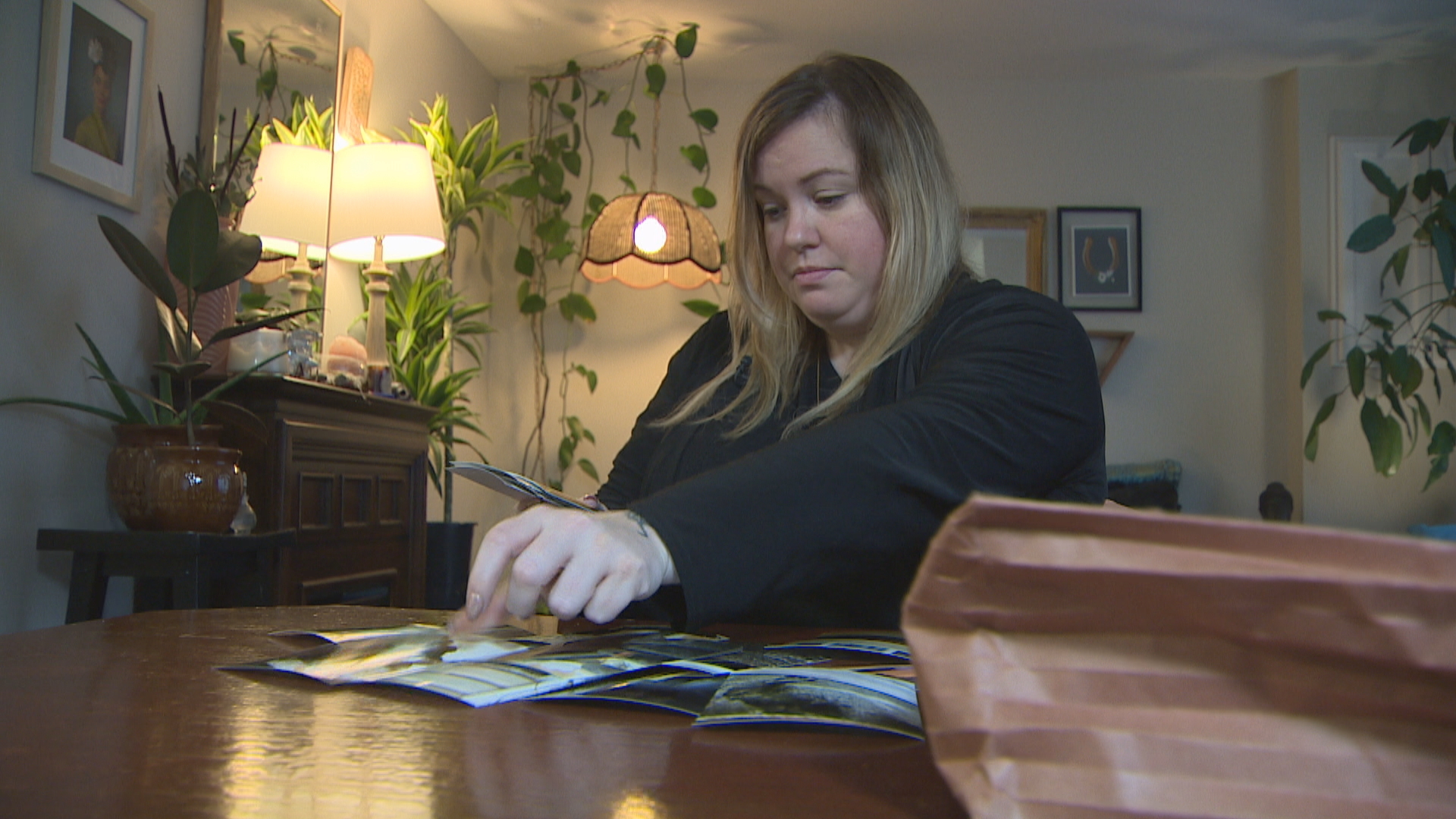 Elton pores over stacks of documents and photos from her research into her home. (Paul Pickett/CBC)