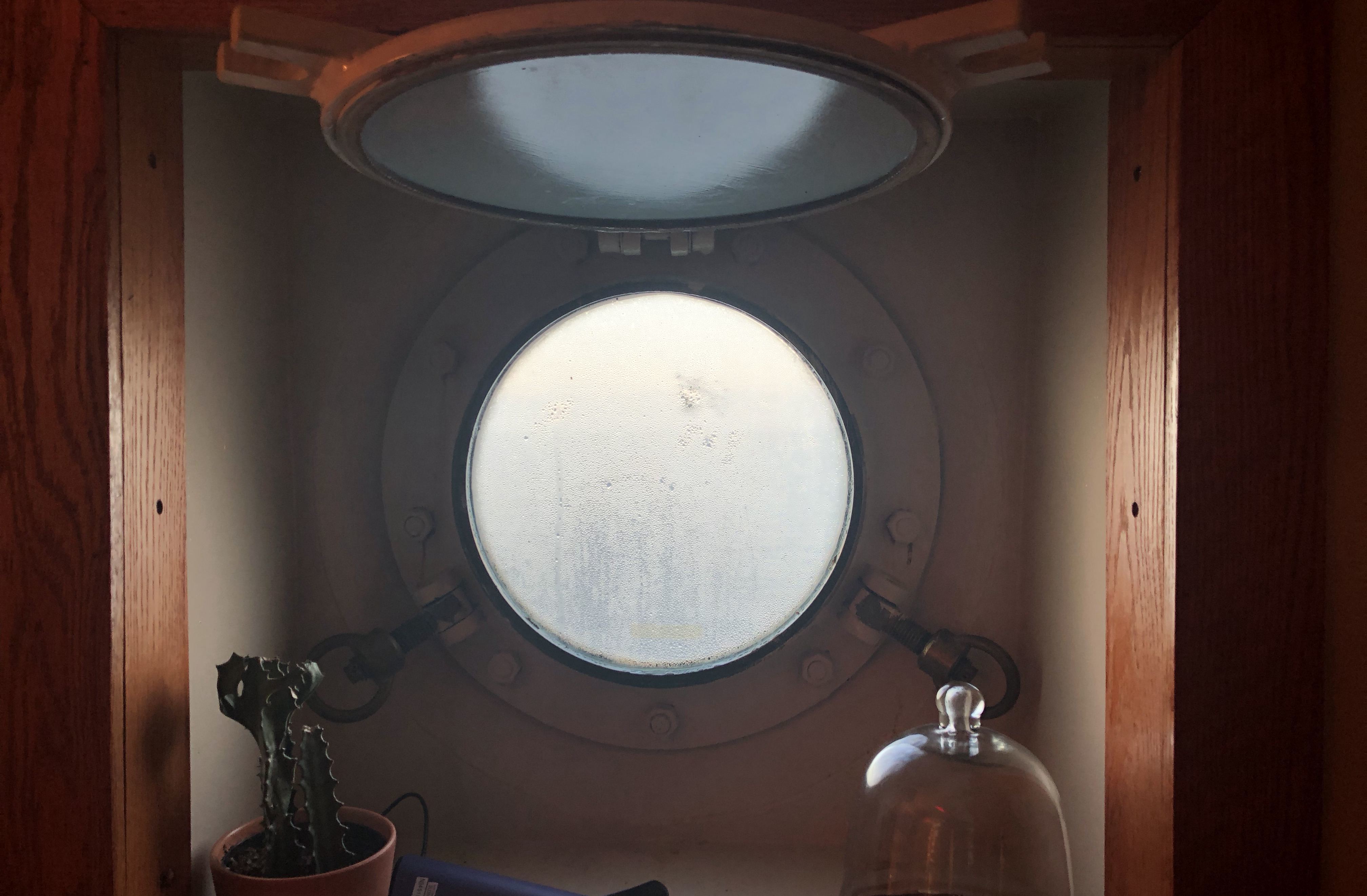 There are no windows down below on a warship; sailors can go days or even weeks without seeing outside light. This is the only porthole on the entire ship and it’s located in the captain's quarters. (Peter Cowan/CBC)