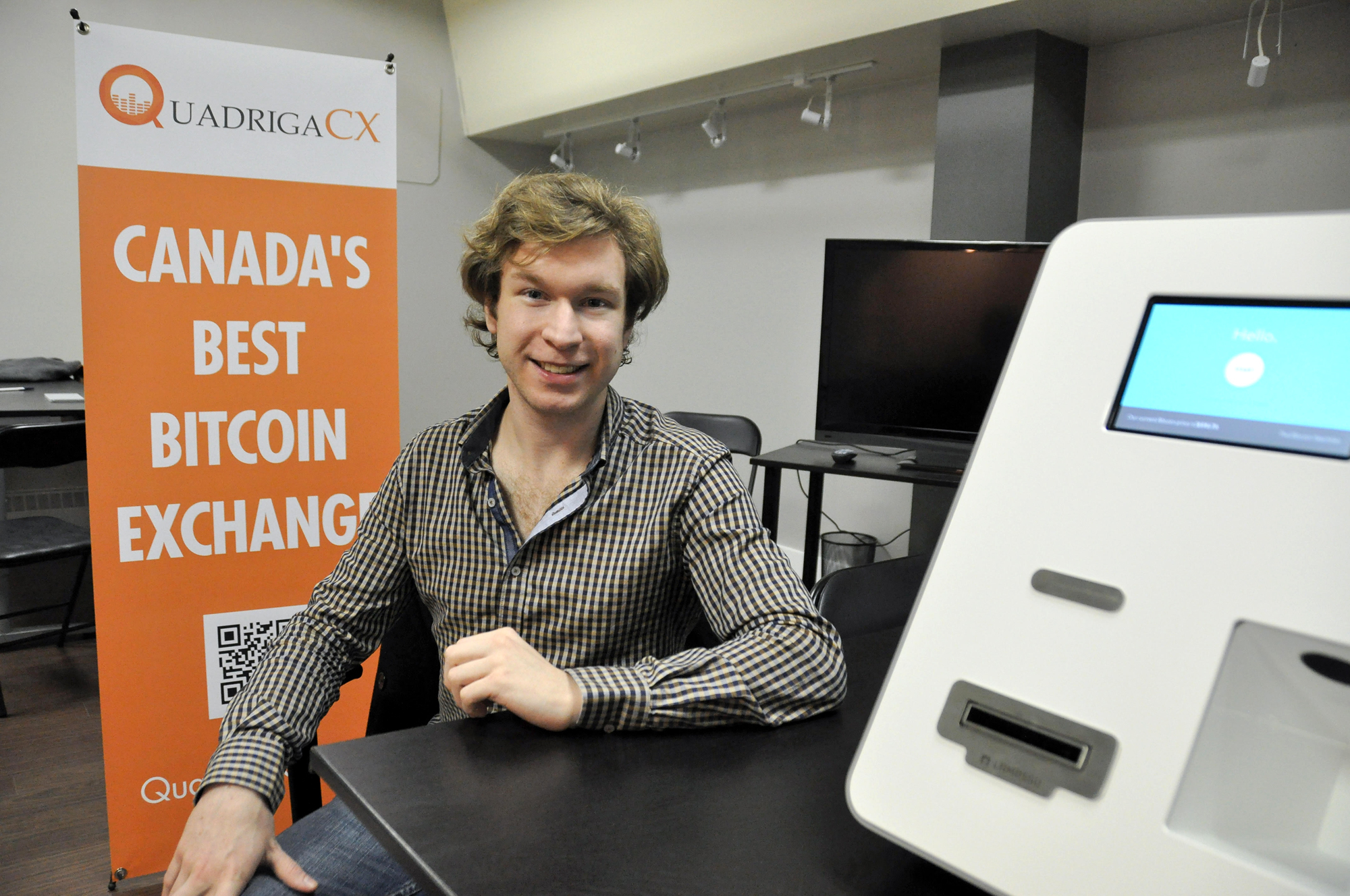 Cotten poses for a local newspaper a month after launching QuadrigaCX in 2014. He’s sitting next to his first bitcoin ATM machine, located at his office in Vancouver’s Gastown. (Stephen Hui/The Georgia Straight)