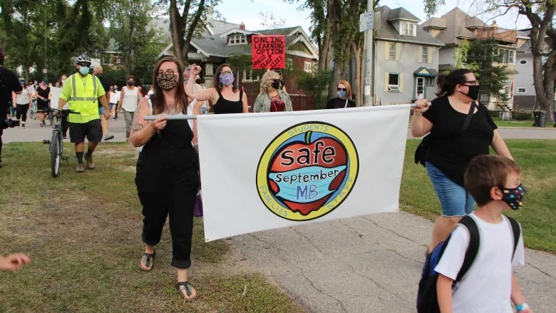 Parents and teachers marched on Aug. 27, calling on the province to bring in more safety measures for students and staff as they return to school. (Walther Bernal/CBC)