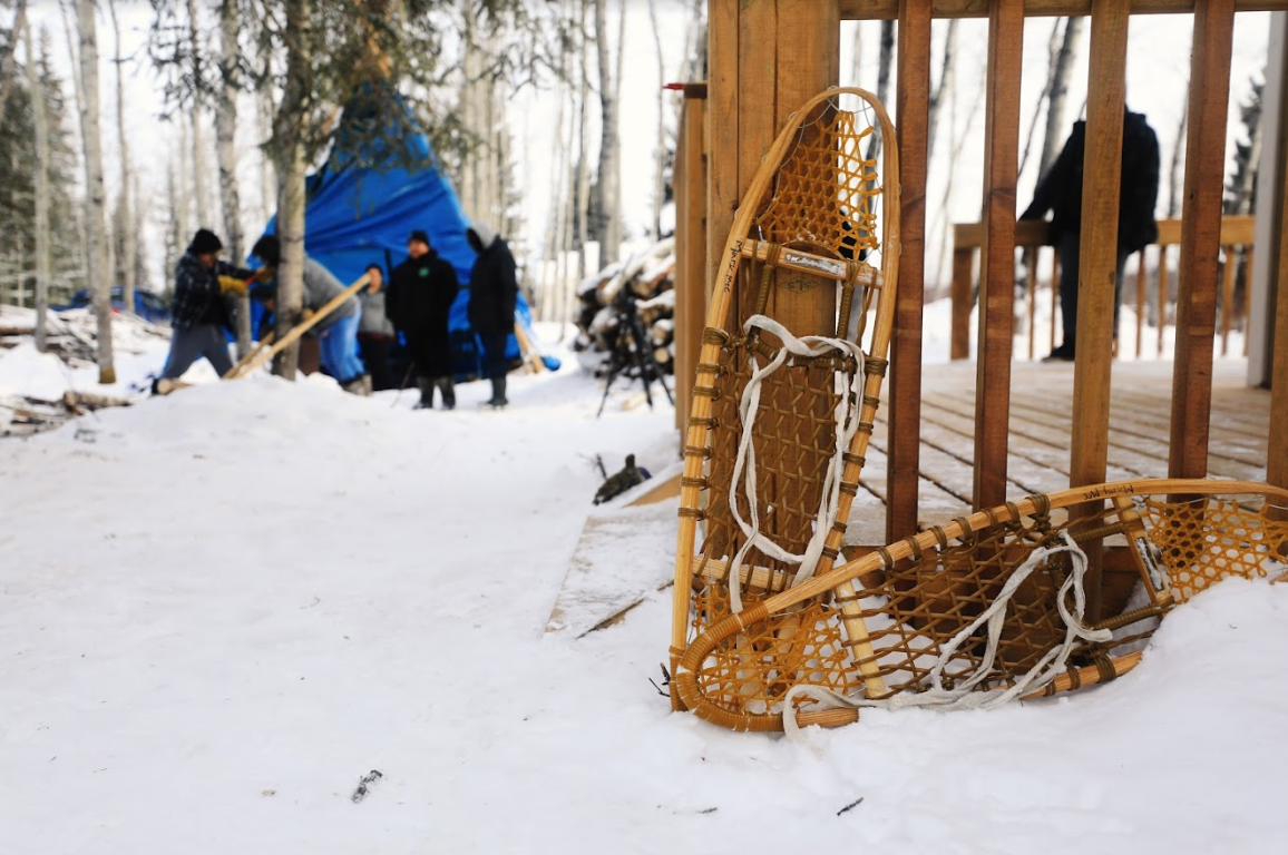 Youth are able to go snowshoeing and engage in log-sawing out at the land-based site. (Heidi Atter/CBC)