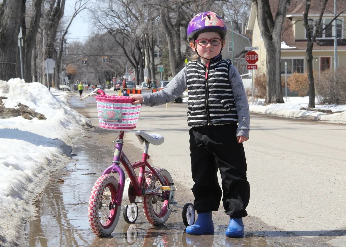 Sia Roberts took her bike down Wolseley Avenue, which was closed to cars, in April. Sia's nursery school was also closed due to COVID-19. (Ian Froese/CBC)