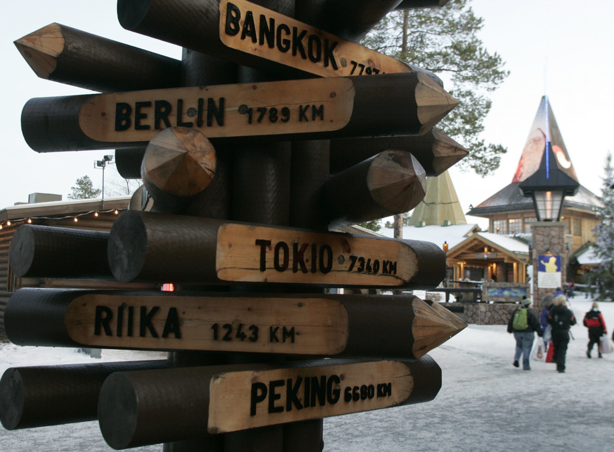 A signpost lists the distance to various cities from the Santa Claus Village on the Arctic Circle in Rovaniemi, Finland. Vesterbacka says the new railway could be used for more than transporting cargo like seafood, natural resources, and raw timber. It could be an important tool for growing tourism in the region while cutting down the emissions from travel by plane and cars, he says. (Kacper Pempel/Reuters)