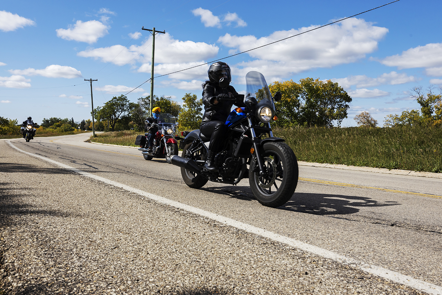 Tejinder Randhawa, who is one of the female riders, leads the group along Main Street beyond Winnipeg's perimeter highway en route to Lockport. (Prabhjot Singh Lotey/CBC)