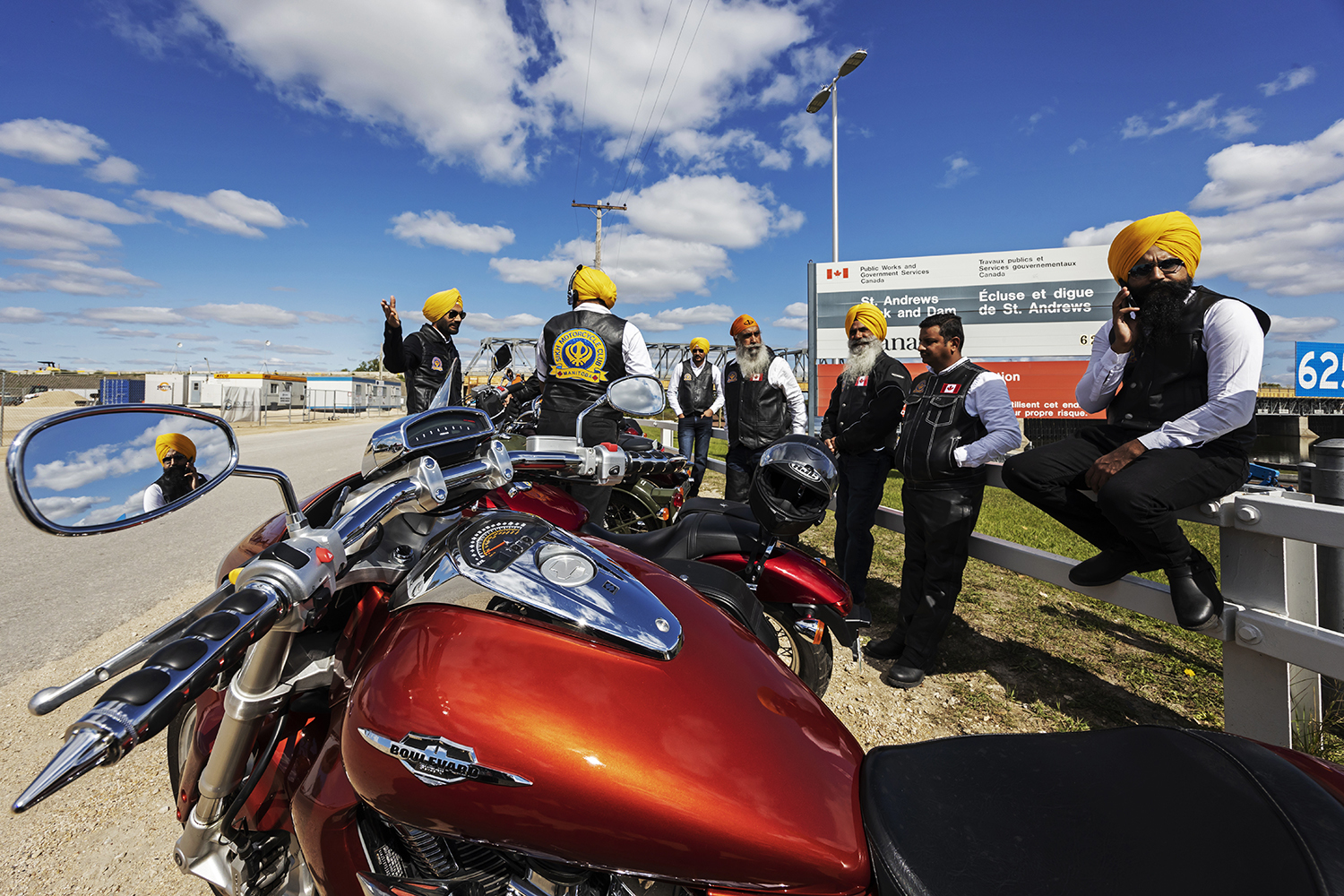 Stopping for a quick break near St. Andrews, Man., after a 50-kilometre stretch. Bikers take frequent breaks during the day to have conversation and stay motivated. (Prabhjot Singh Lotey/CBC)