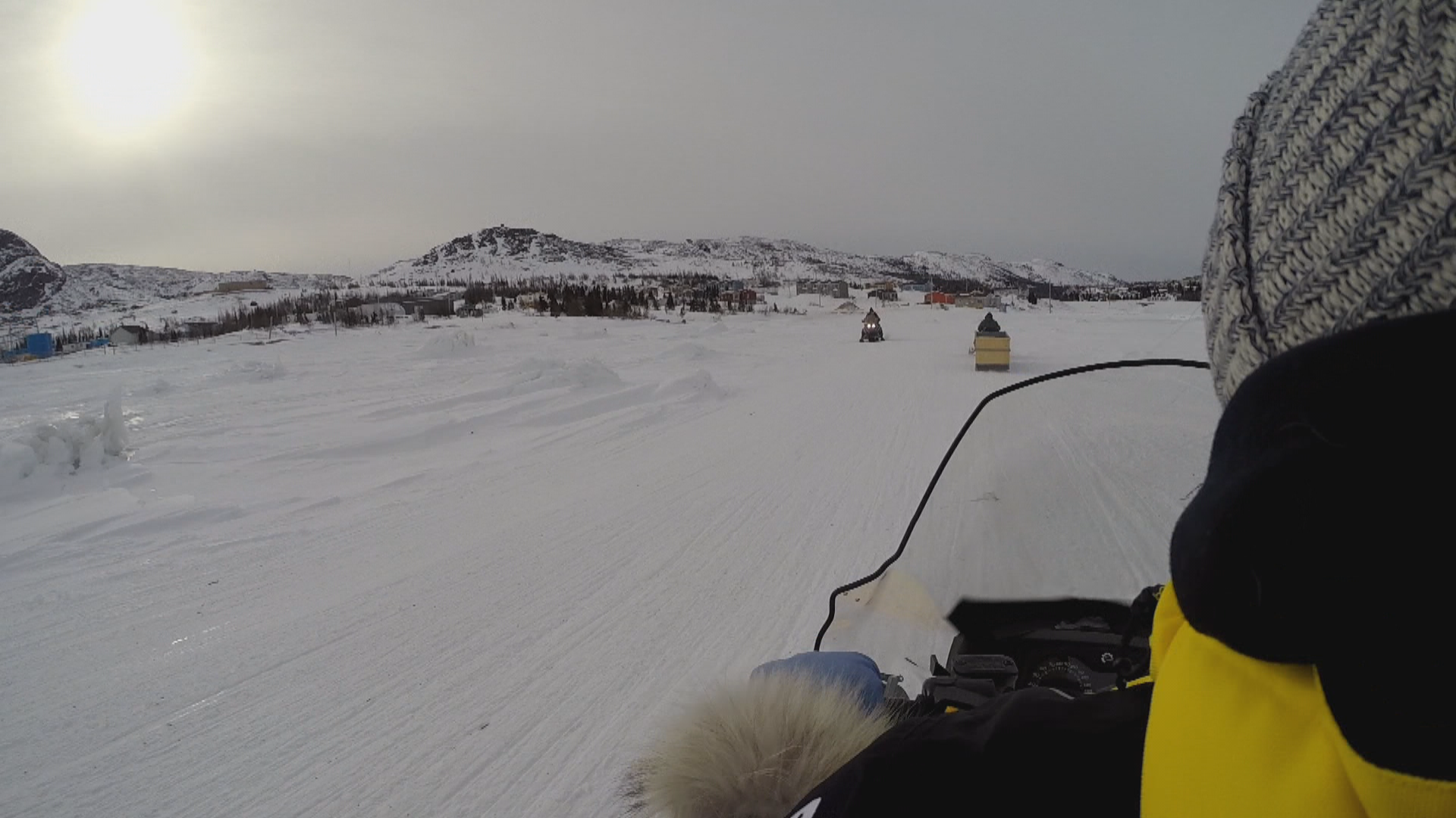 Riding a snowmobile across the ice. (Jen White/CBC)