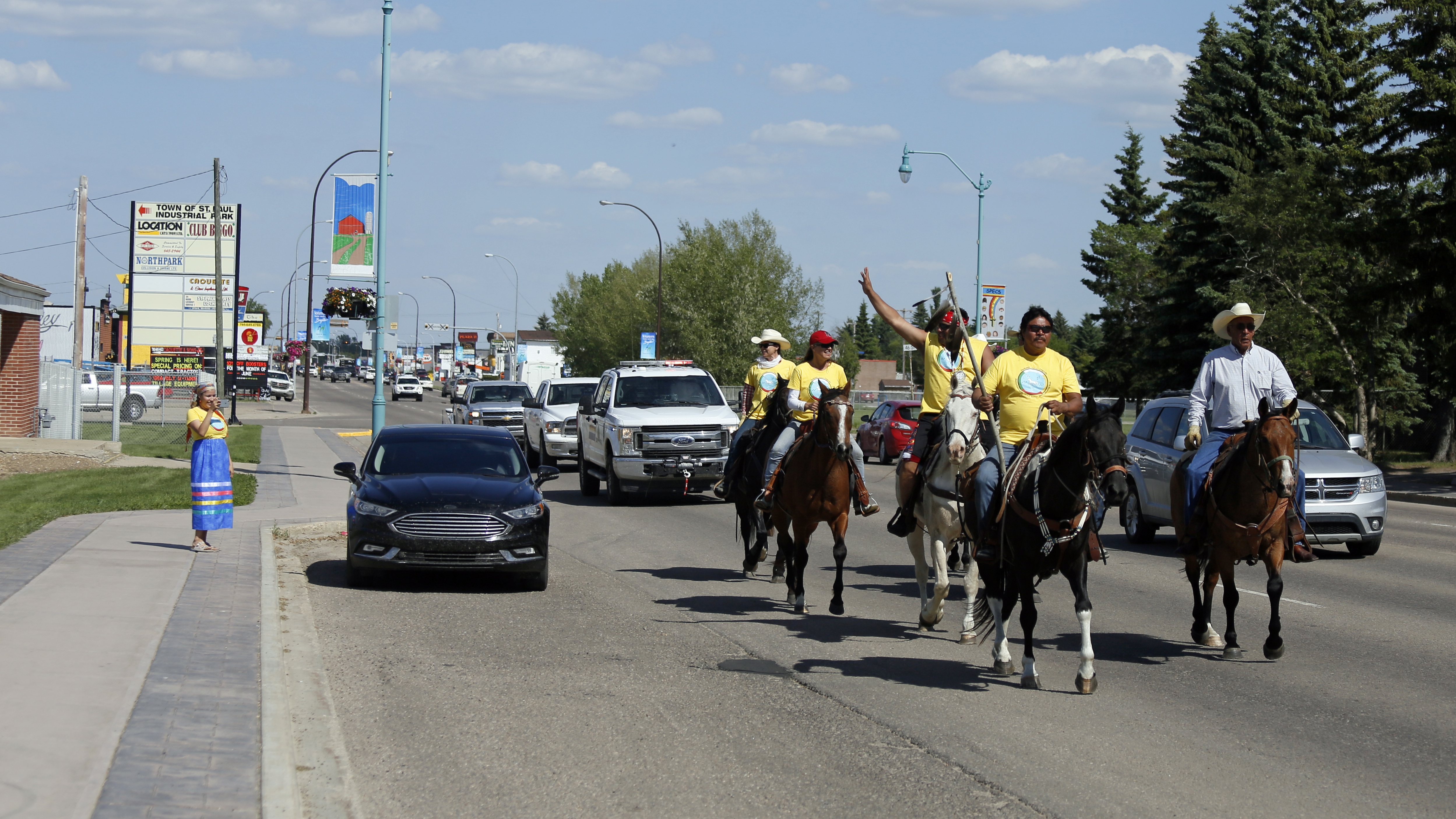 The riders continued their journey through town and waved to people on the street.