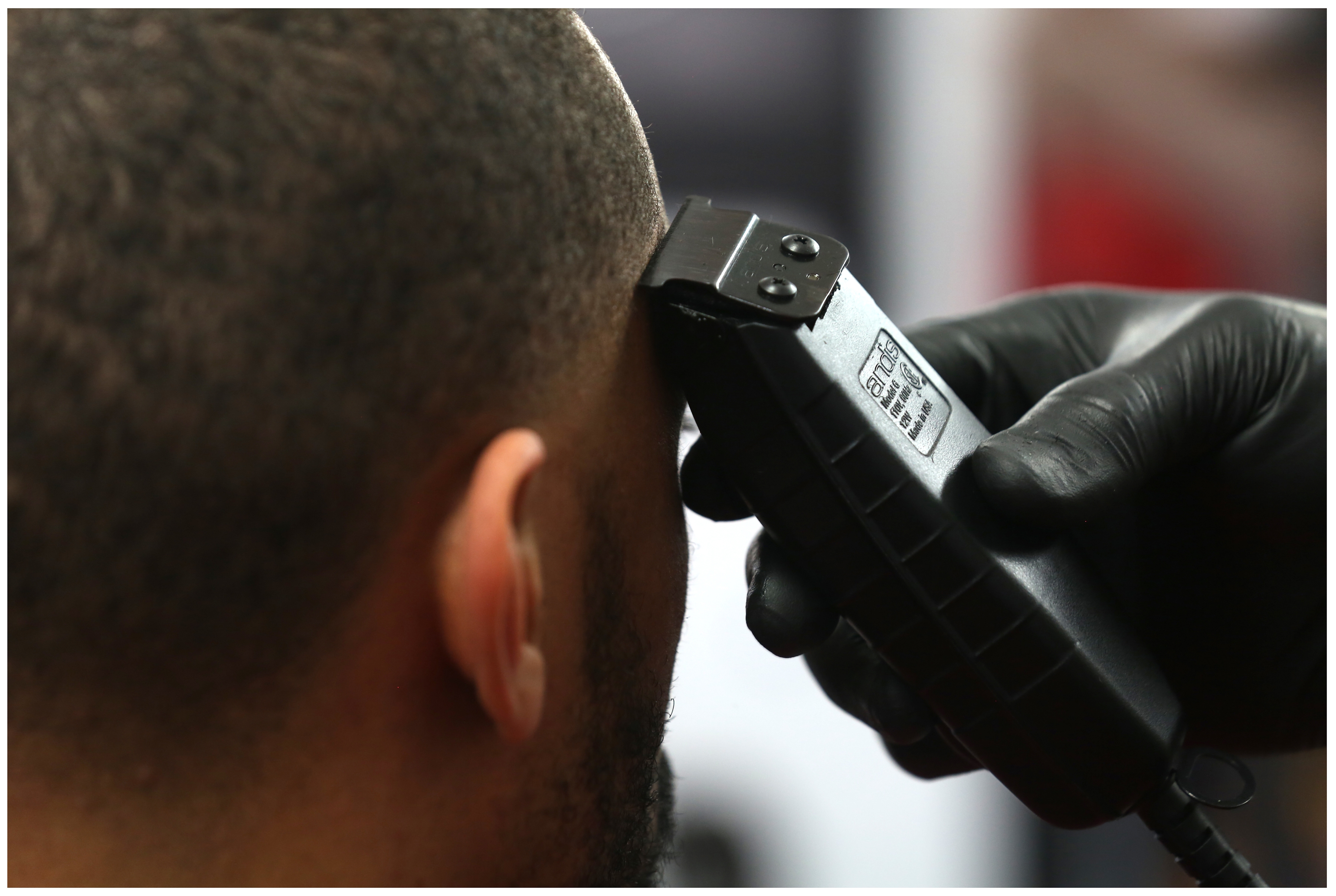 Coron Williams, a star player with The Edge basketball team, gets  his hair trimmed. (Paul Daly)