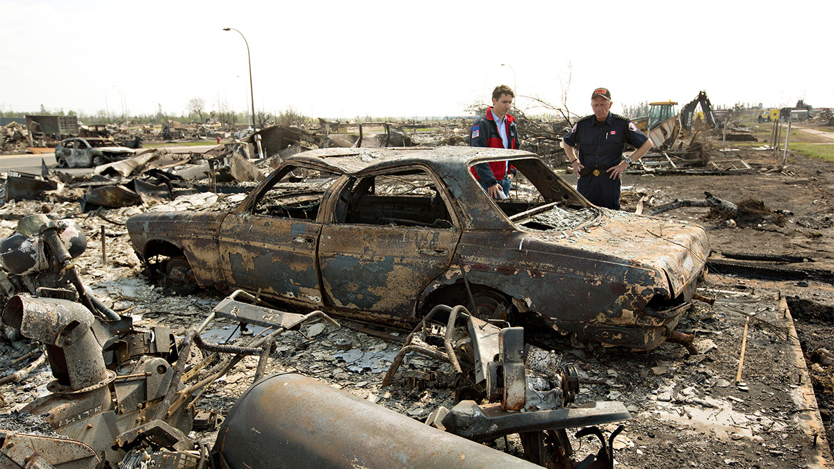 Prime Minister Justin Trudeau surveys the damage of the Fort McMurray wildfire with Darby Allen. (Canadian Press)