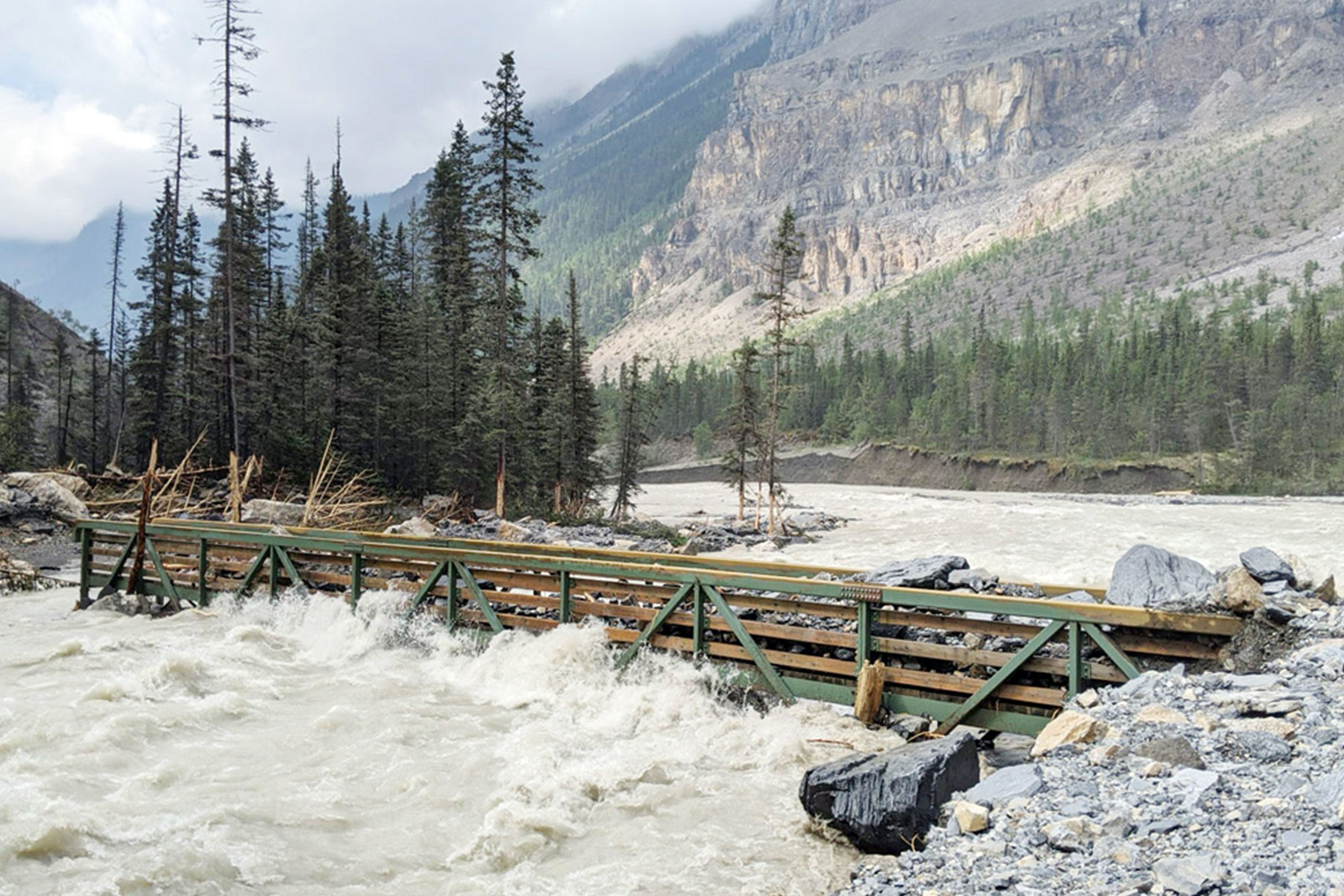 A broken bridge is seen near Whitehorn Campground along the Berg Lake Trail during the flood in the summer of 2021.