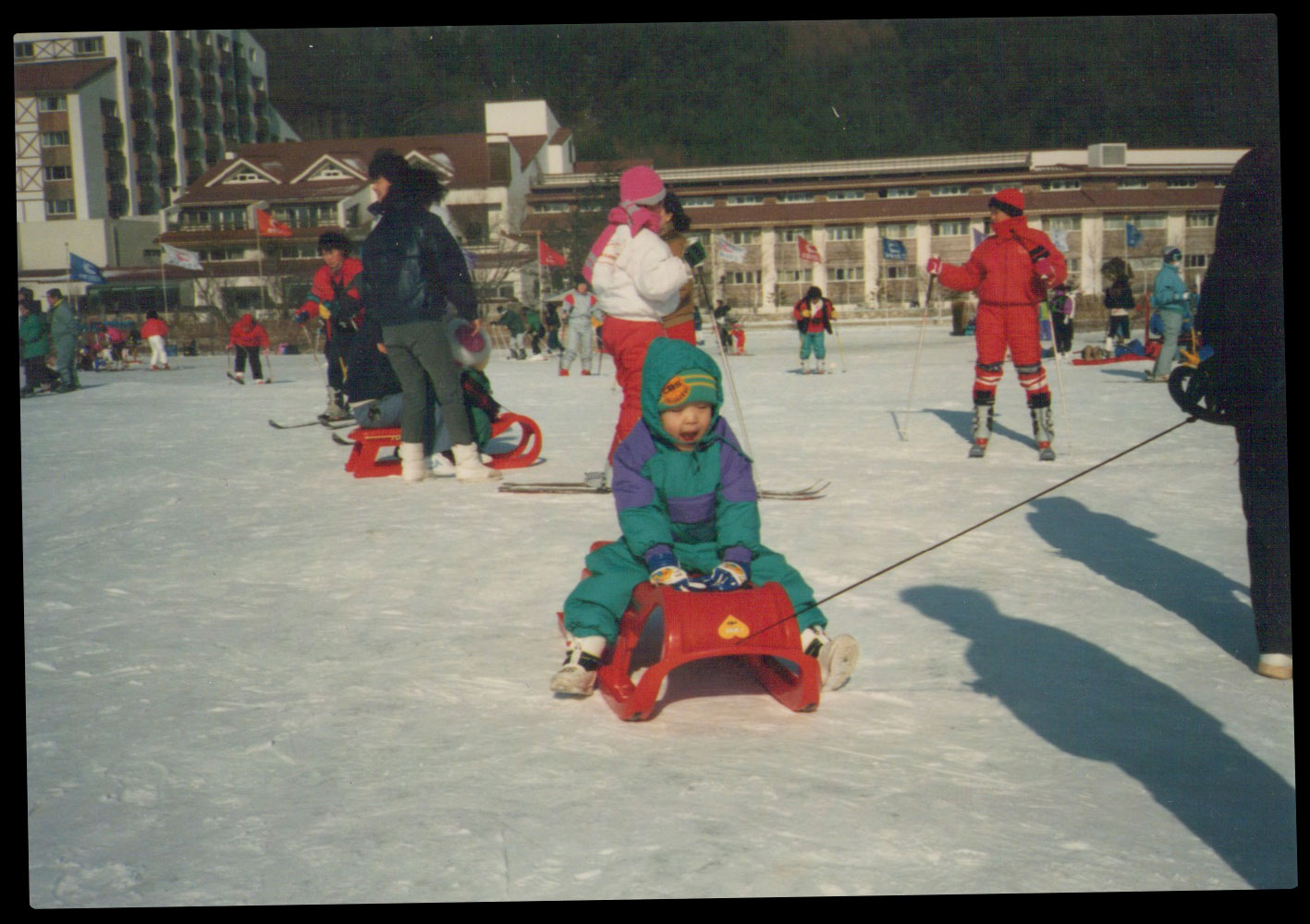 Me playing on the ice surrounded by other people at the Yongpyong Ski Resort during a family vacation in the late 1980s.